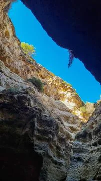 Looking up through a limestone sea cave toward blue sky, Algarve, Portugal Fotos de archivo