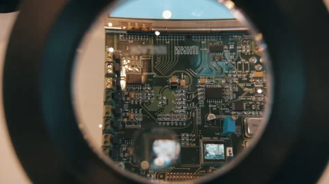 Looking through a magnifying glass on a PCB with elements to detect defects Stock Footage 68370836