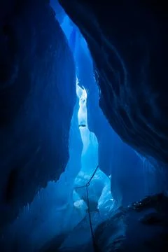 Looking through massive tunnel underground inside a glacier back toward the e Stock Photos