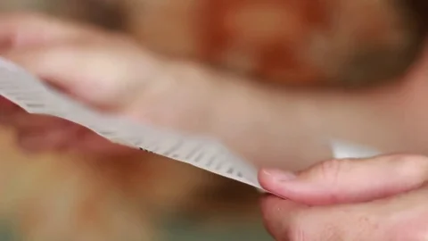 Looking through the medicine instruction list Stock Footage 79786009