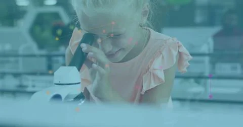Looking through microscope, child in laboratory with scientific data image Stock Photos