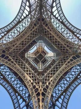 Looking up through middle of Eiffel Tower from underneath in Paris. Stock Photos