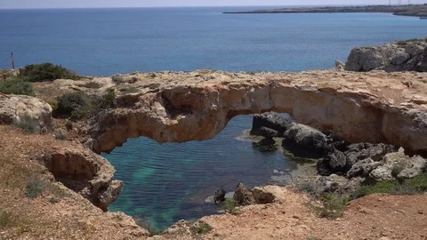 Looking through natural rock arch at the seashore. Beautiful seascape Stock Footage 76856294