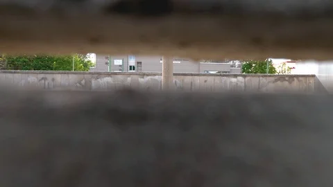 Looking through an old piece of the Berlin Wall Stock Footage 79910978
