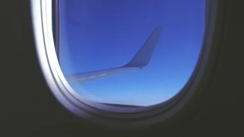 Looking through the plane window to the sky and wing. Stock Footage 115938566