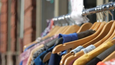 Looking through rack of clothing outside hangers Stock Footage 106068735