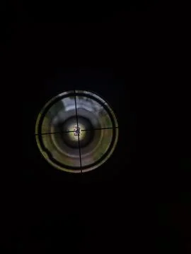 Looking Through a Rifle Scope at a Man Setting up a Target Stock Photos