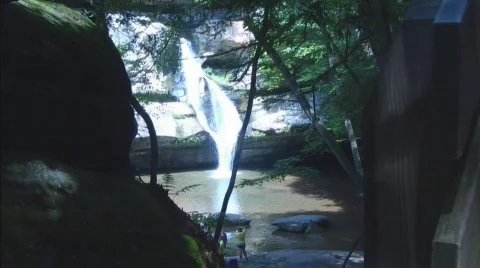 Looking Through Rock Formations at Distant Water Fall Video stock 761465