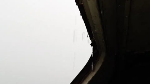 Looking Up Through Roof Window of Abandoned Trailer at Heavy Rain Stock Footage 339590235