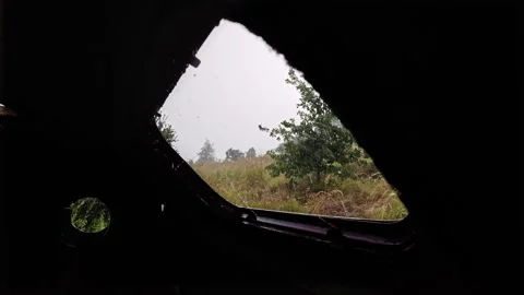 Looking Up Through Roof Window of Abandoned Trailer at Heavy Rain Stock Footage 339590344