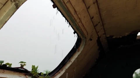 Looking Up Through Roof Window of Abandoned Trailer at Heavy Rain Stock Footage 339591159