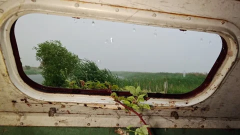 Looking Up Through Roof Window of Abandoned Trailer at Heavy Rain Stock Footage 339591578