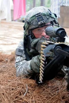 Looking through the sight of his 240B machine gun, a paratrooper with the ... Stock Photos