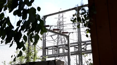 Looking through tree branches to electrical substation 1 Stock Footage 162758340