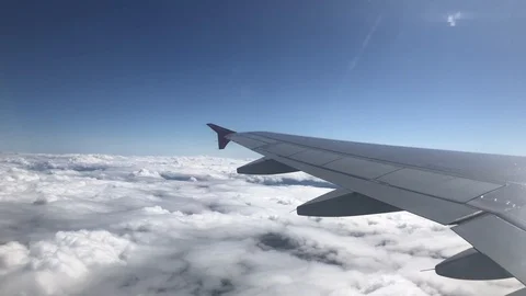 Looking through window aircraft during flight in wing with a nice blue sky Stock Footage 91168440