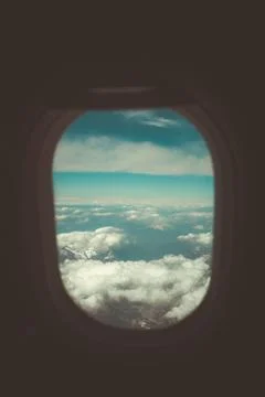 Looking through window aircraft during flight in wing with a nice blue sky Stock Photos