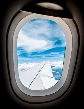 Looking through window aircraft during flight in wing blue sky Stock Photos