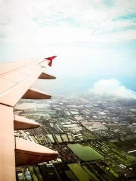 Looking through window aircraft in wing aerial view of landscape and sky vint Stock Photos