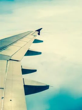Looking through window aircraft in wing aerial view of landscape and sky vint Stock Photos