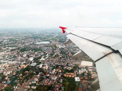 Looking through window aircraft in wing aerial view of landscape and sky Stock Photos
