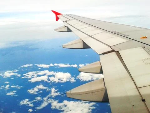 Looking through window aircraft in wing aerial view of landscape and sky Stock Photos