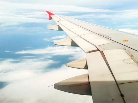 Looking through window aircraft in wing aerial view of landscape and sky Stock Photos