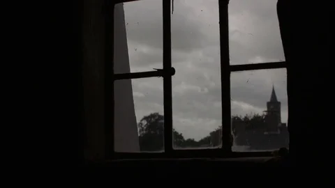 Looking through a window at a church while the sails of a windmill pass by Stock Footage 85214512
