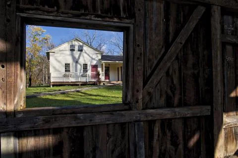 Looking through the window of an empty damaged barn Stock Photos
