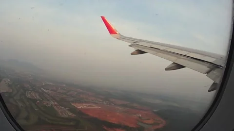 Looking through a window at the fields during takeoff Video stock 133574130