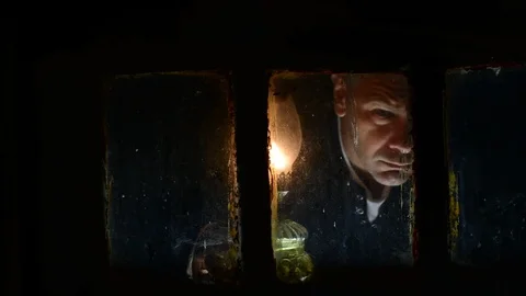 Looking through a window in the light of a kerosene lamp Stock Footage 112921398