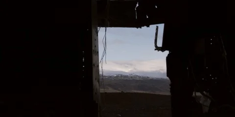Looking through window of plane wreck at Icelandic mountains Stock Footage 122910460