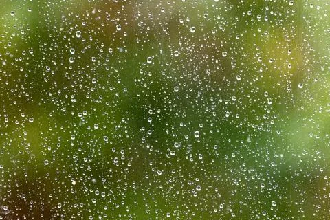 Looking through a window with rain drops on the outside and a shallow depth.. Stock Photos