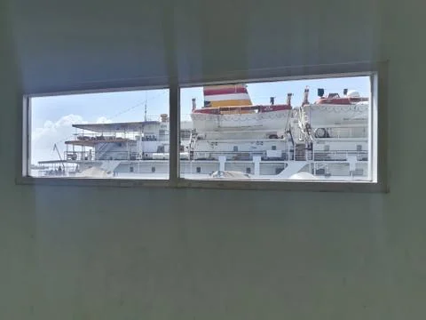 Looking through window to see the ship at the bright day 스톡 사진