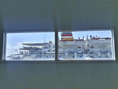 Looking through window to see the ship at the bright day Photos