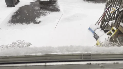 Looking through window at snow falling on backyard in February in New Jersey Stock Footage 344814789