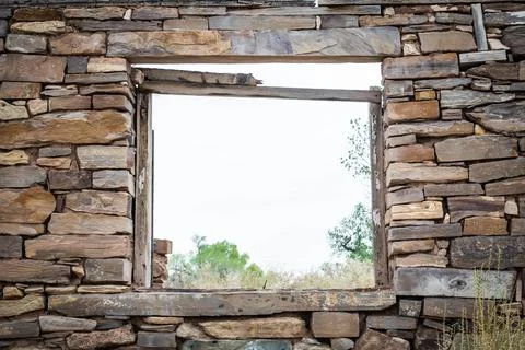 Looking through the window in the stone ruins of an old house Stock Photos