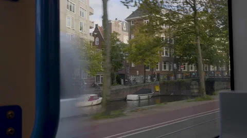 Looking through window of tram moving along river in Amsterdam Stock Footage 151339132