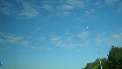 Looking through windshield up in blue sky at summer sunny day. Wide angle view Stock Footage 184553126