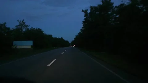 Looking through windshield straight at summer evening, traffic lights Stock-Footage 184561788