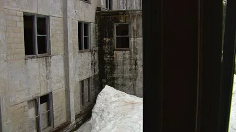 Looking thru Broken Glass of Buckner Building Ruin in Snow at Gaping Windows. Stock Footage 12359804