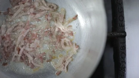 Looking from the Top and Cooking Thin Slices of Bacon Stock Footage 129340059
