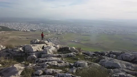 Looking towards the city while people on the top of the mountain take pictures Stock Footage 146060522