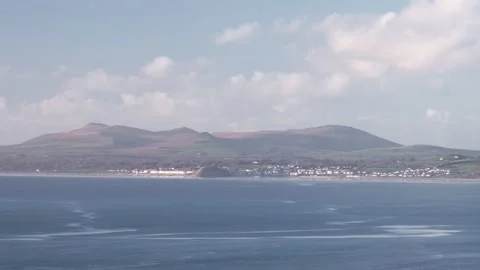 Looking towards Criccieth and the Llŷn Peninsula, Gwynedd, Wales, UK Stock Footage 324760669