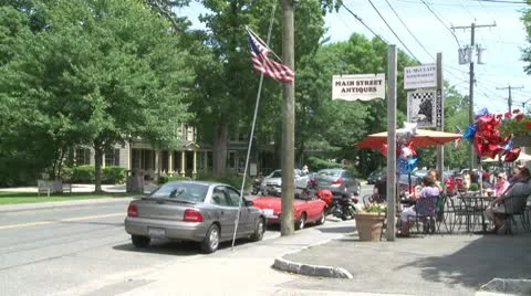 Looking at traffic going by a small cafe Stock Footage 10771934