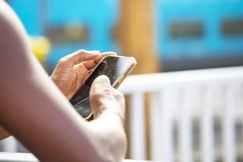 Looking at the train schedule on her smartphone at the platform Stock Photos