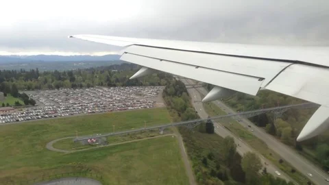 Looking trough window of an aircraft, airplane or plane wing. View from plane Stock Footage