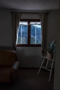 Looking trough a window a mountain full of trees Stock Photos