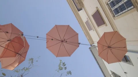 Looking up at umbrellas hanged in the air Stock Footage 83537169