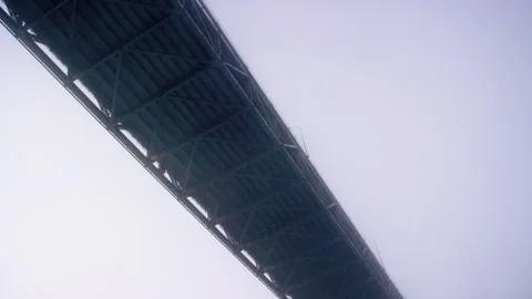 Looking up at underside of Bay Bridge in San Francisco CA in thick fog at dawn Stock-Footage 242830972