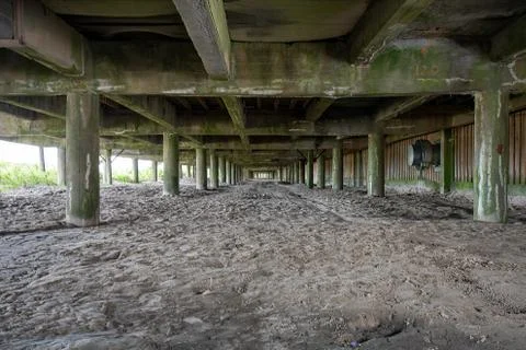 Looking at the Underside of a Boardwalk With Sand Underneath Stock Photos